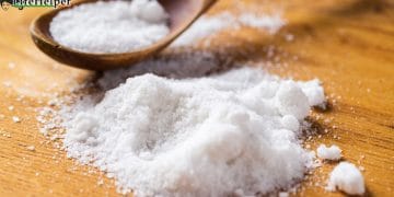 Spoon and heap of salt on the table