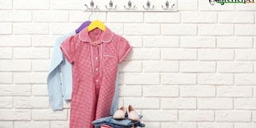 Female clothes on hangers on a brick wall background